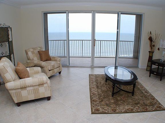 Spacious Living room with tile floors, and glass doors to private balcony