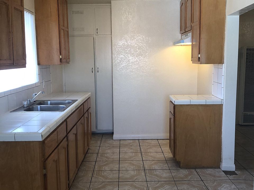 The kitchen with tile flooring.