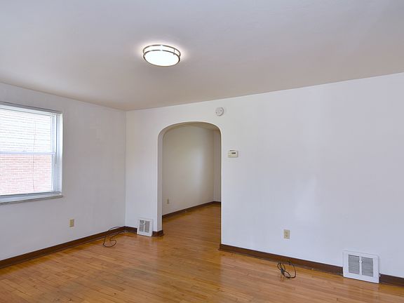 Spacious Living Area with original hardwood flooring throughout