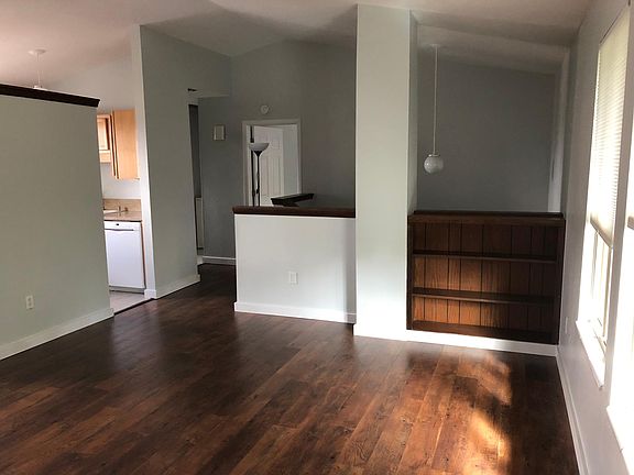Large family room with vaulted ceilings and built-in shelving