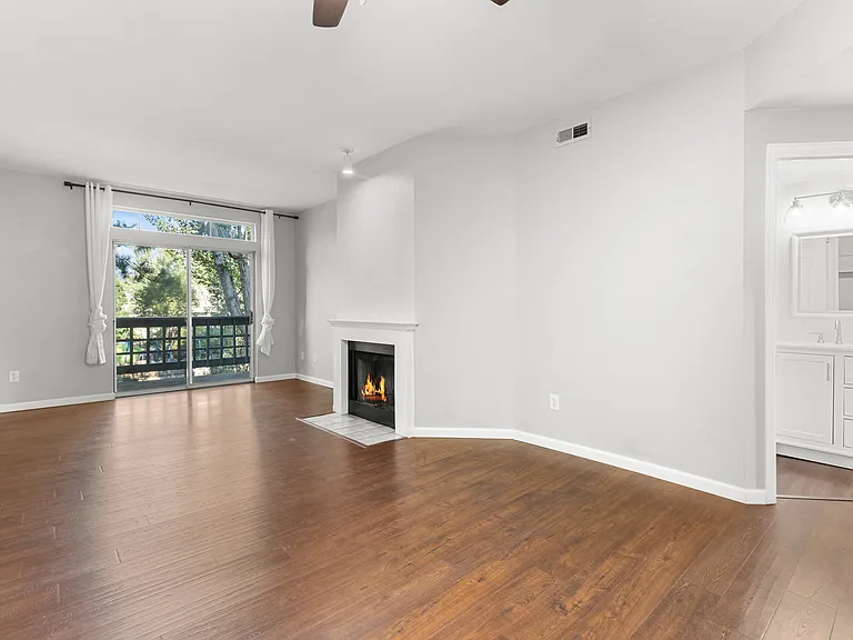 Open living area with private balcony access, and a full bathroom conveniently located nearby.