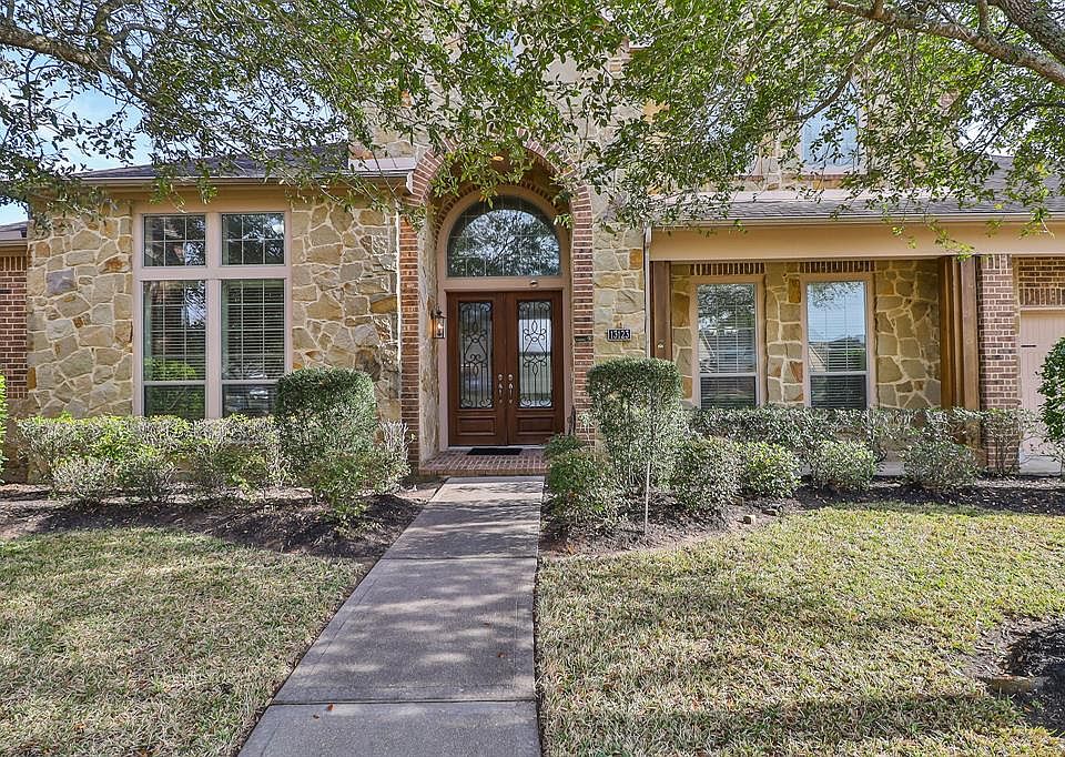 Gorgeous brick and earthy stone surrounds the front patio and entrance way