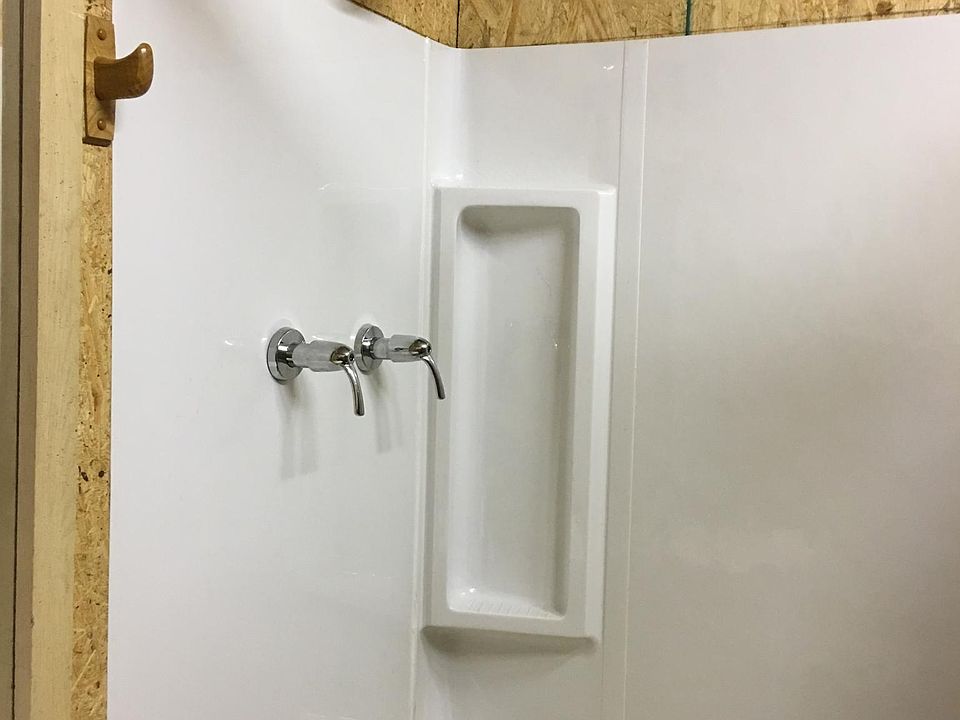 TUB AND SHOWER UNIT RIGHT AFTER INSTALLATION. WALLS HAVE BEEN PAINTED WHITE.