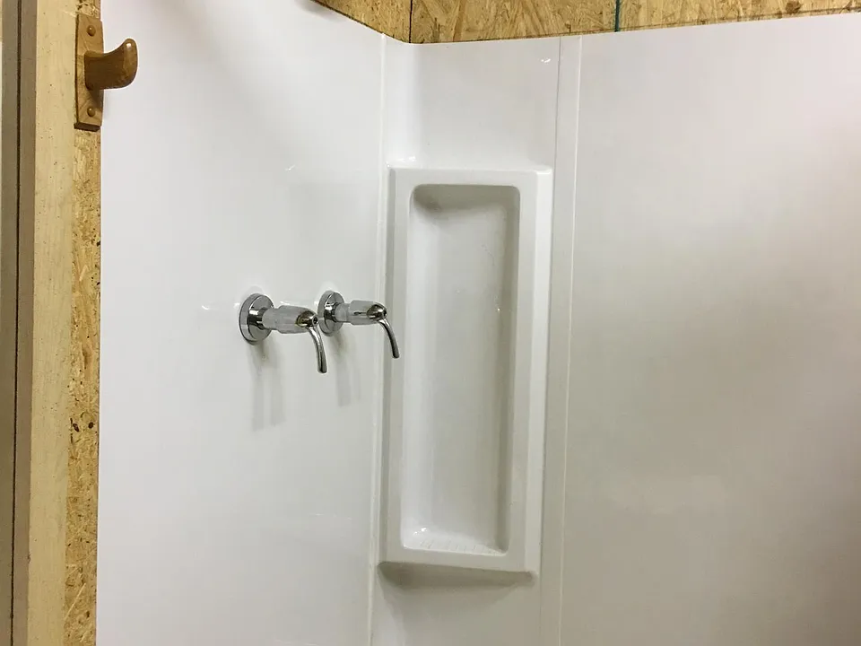 TUB AND SHOWER UNIT RIGHT AFTER INSTALLATION. WALLS HAVE BEEN PAINTED WHITE.