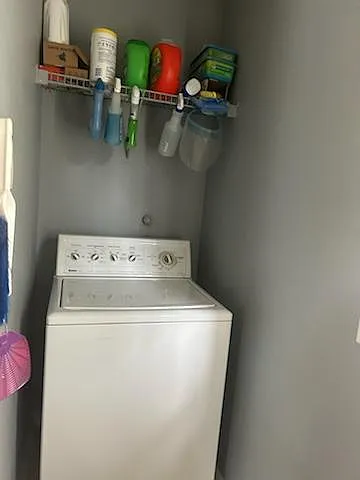 Shared laundry room with washer and dryer.
