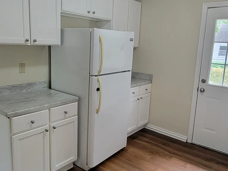Kitchen with door to backyard and small patio
