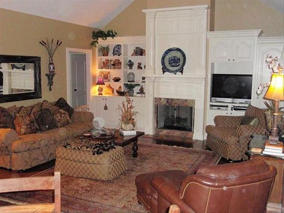 DEN AREA WITH CATHEDRAL CEILINGS AND FIREPLACE