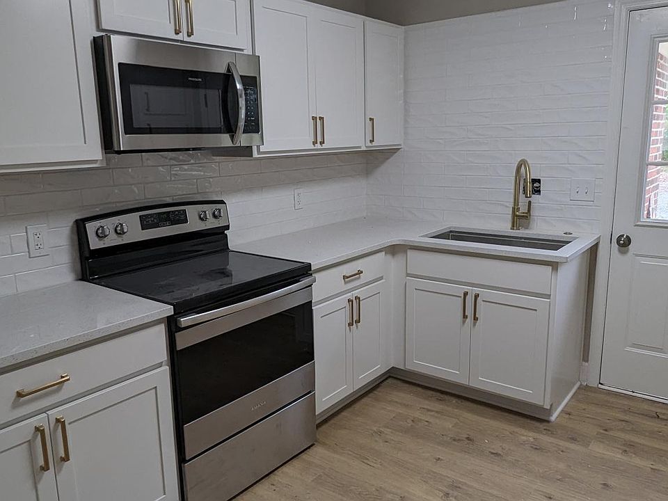 This kitchen has new cabinets, countertops, flooring, faucets, cabinet hardware, appliances, and more!