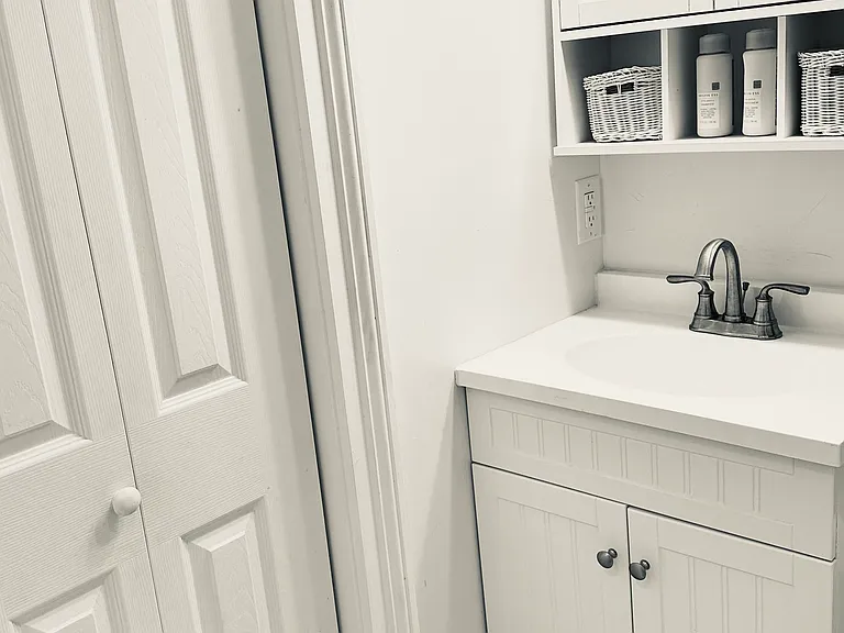 Vanity with storage.
Full closet with adjustable shelves for linens, toiletries etc.
Modest hampers fit below as well.