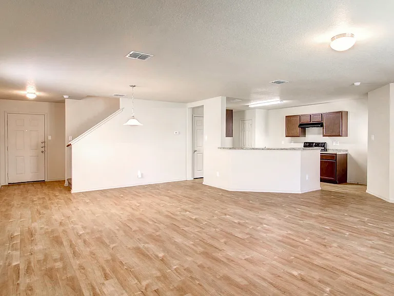 Bright open-concept living area with modern kitchen and wood flooring, ideal for entertaining. Bright open-concept living area with modern kitchen and wood flooring, ideal for entertaining.