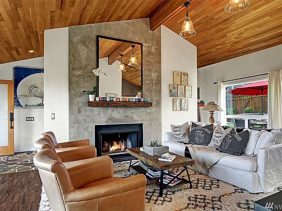Open living area with gas fireplace overlooking back yard