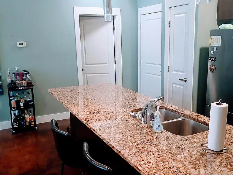 Different view of kitchen looking towards front door and laundry room