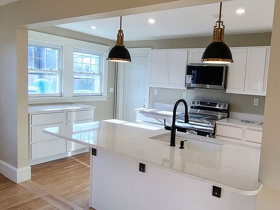 A completely new kitchen with marble countertops, spacious storage and a large island.