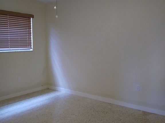 Cozy bedroom with ceiling fan and closet.