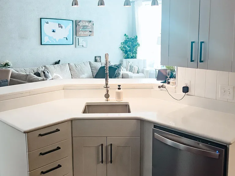 White soft close kitchen cabinets, updated hardware and stainless steel appliances.