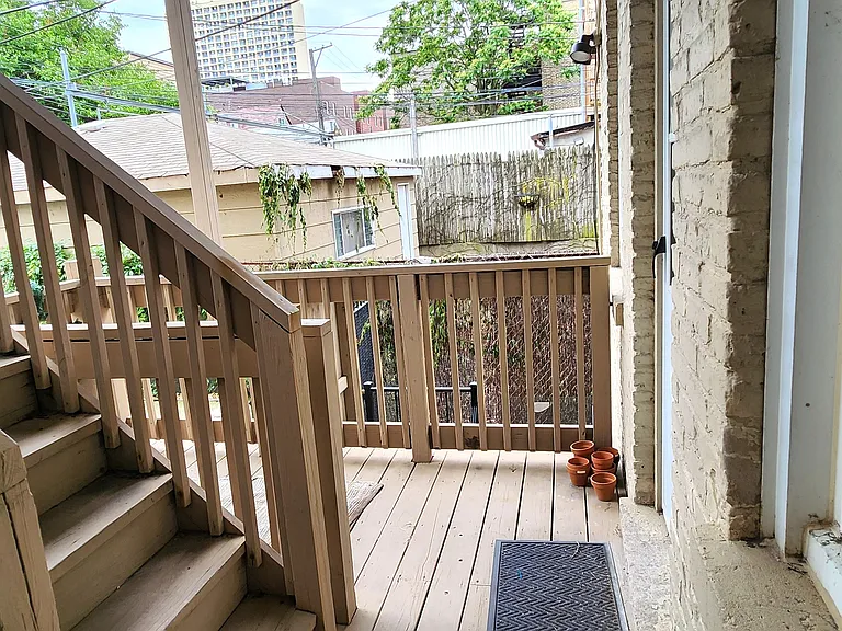 Porch with apartment window and door on right
