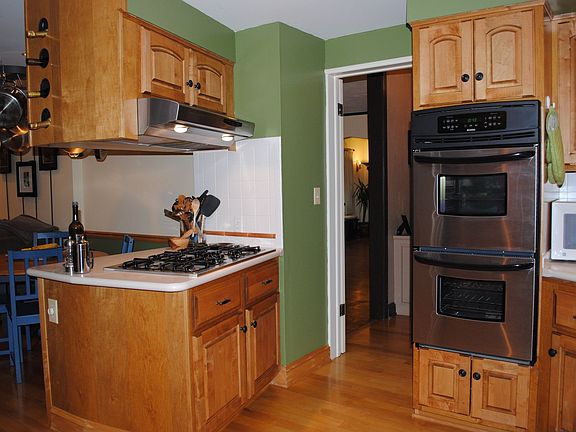 Stainless steel appliances, corian countertops, and five gas burner stove