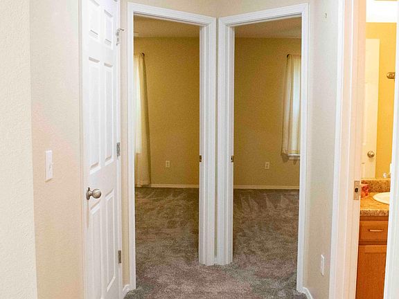 Hallway showing 2 extra bedrooms, bathroom, and laundry room