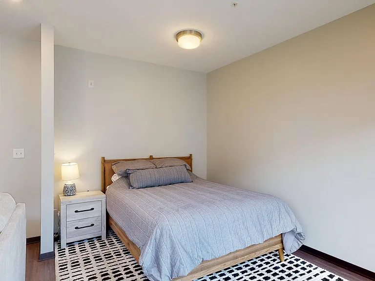 Our Nest studio apartments offer a cozy sleeping area with modern design and natural light.