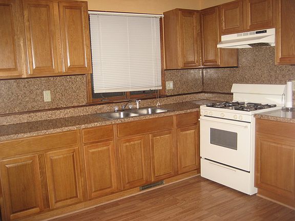 Modern applianced (gas stove and refrigerator) eat in kitche