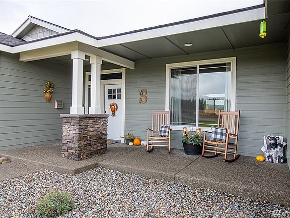 Welcoming covered front porch! This house is also equipped with photocell exterior lighting, & high plugs for holiday lighting.