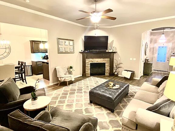 Living room, common areas have tile floors that look like wood, easy to maintain. Gas fireplace.