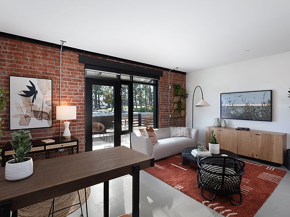 Exposed brick feature wall in living area at Star Harbor Apartments & Townhomes in Alameda, CA.