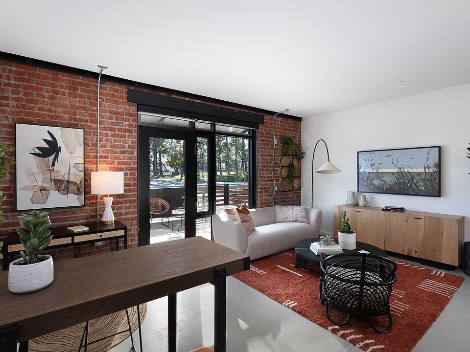 Exposed brick feature wall in living area at Star Harbor Apartments & Townhomes in Alameda, CA.