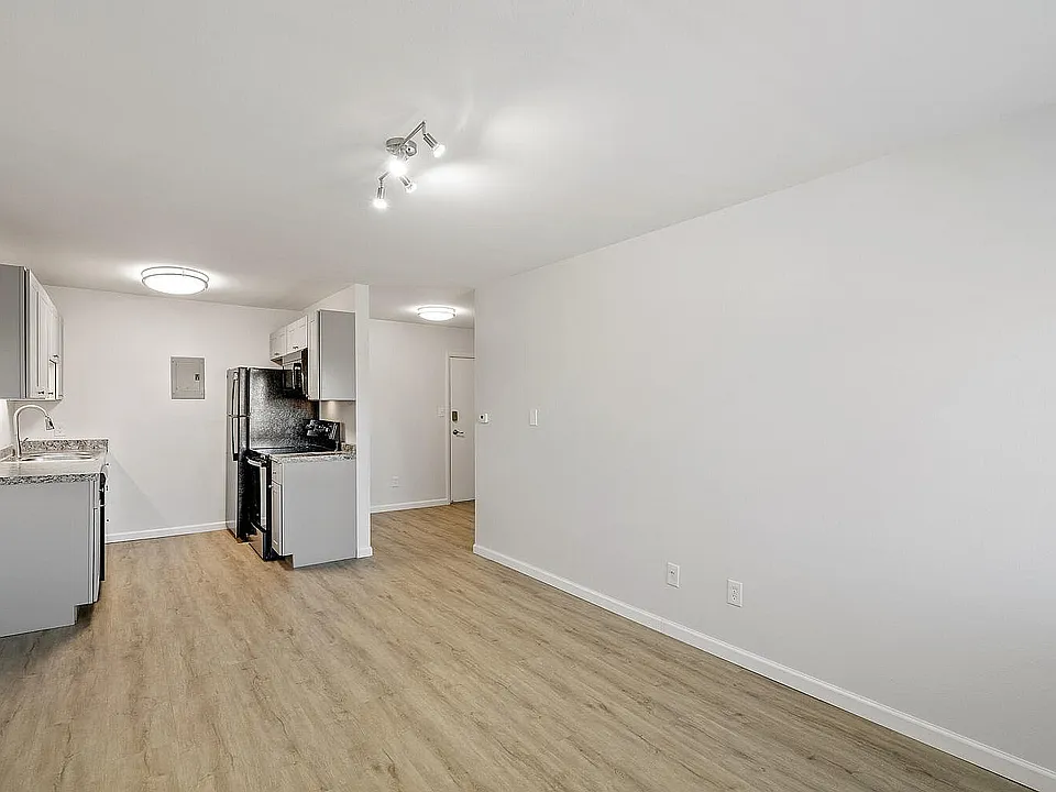 Bright, modern kitchen with sleek grey cabinets, stainless steel appliances, and inviting open layout.
