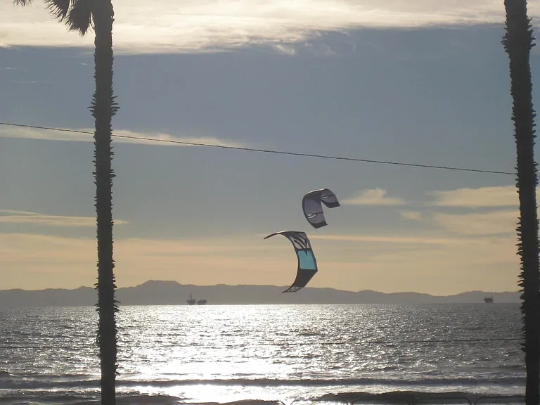 My amateur photo of the sail or wind surfers in front of your private beach front patio/balcony