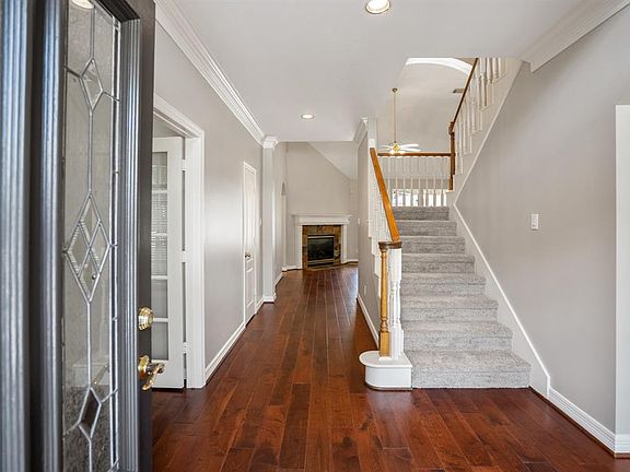 Welcoming 2 story foyer with gleaming wood floors that leads into a delightful home that has been freshly painted and carpeted.
