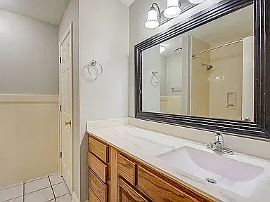 Clean and well-maintained full bathroom with updated vanity.