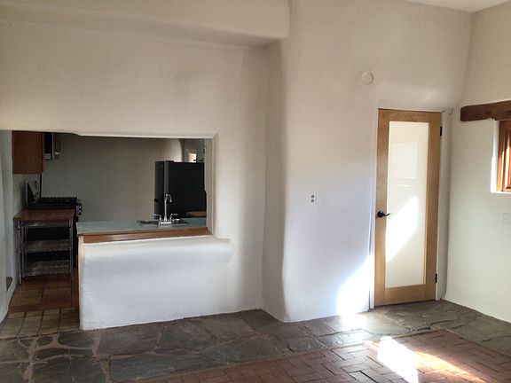 Large room with view of kitchen
