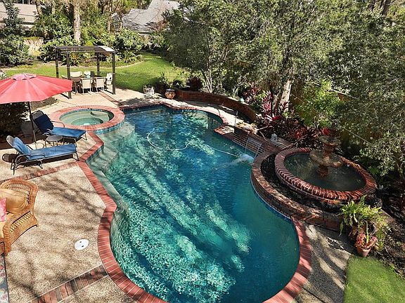 Just take a look at this fabulous pool and amazing backyard!! The lot size is 18,262 sq ft.