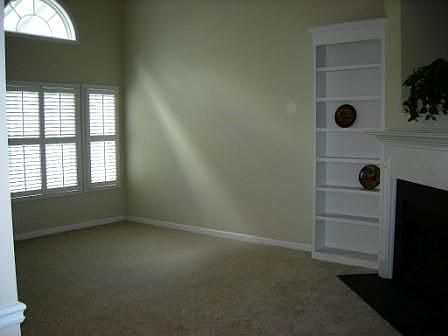 Great Room features gas log fireplace, towering bookcases, 