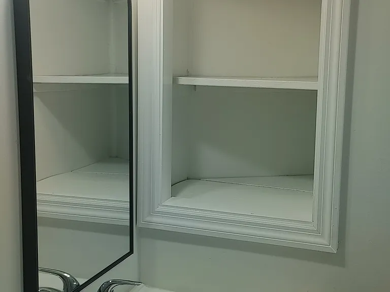Built-in storage next to the bathroom sink