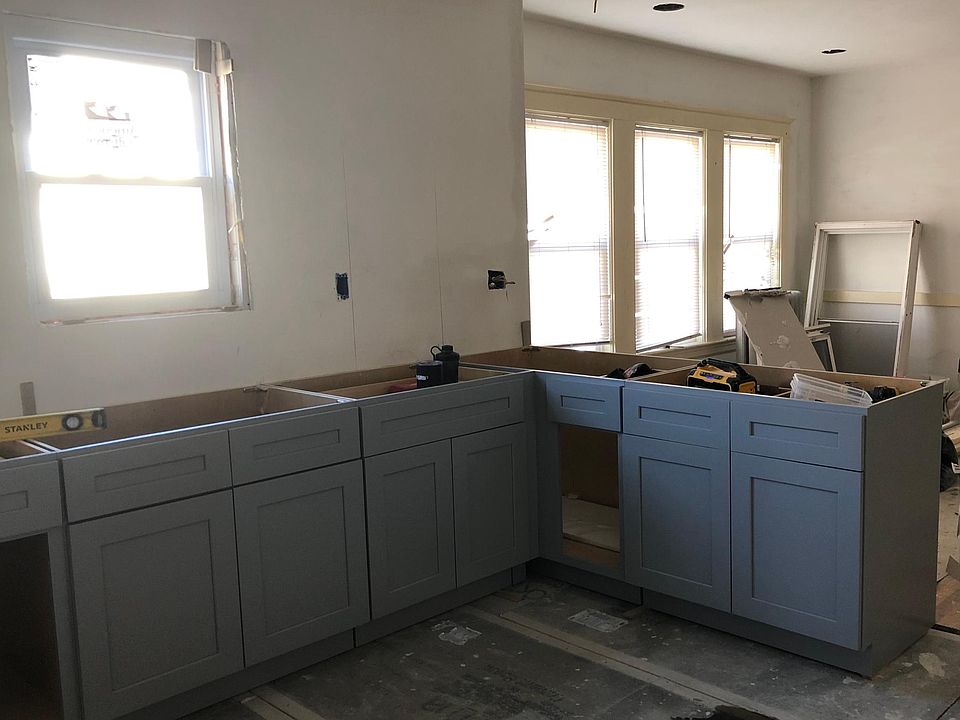 Kitchen with new cabinets and floor, connects to dining room