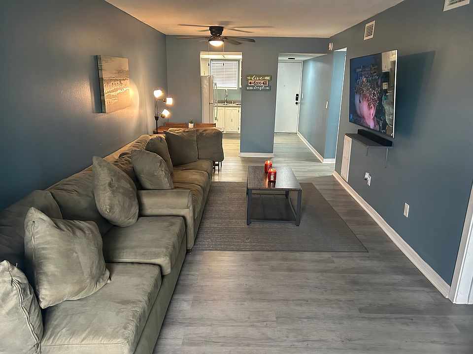 living room/kitchen/front door entrance view.