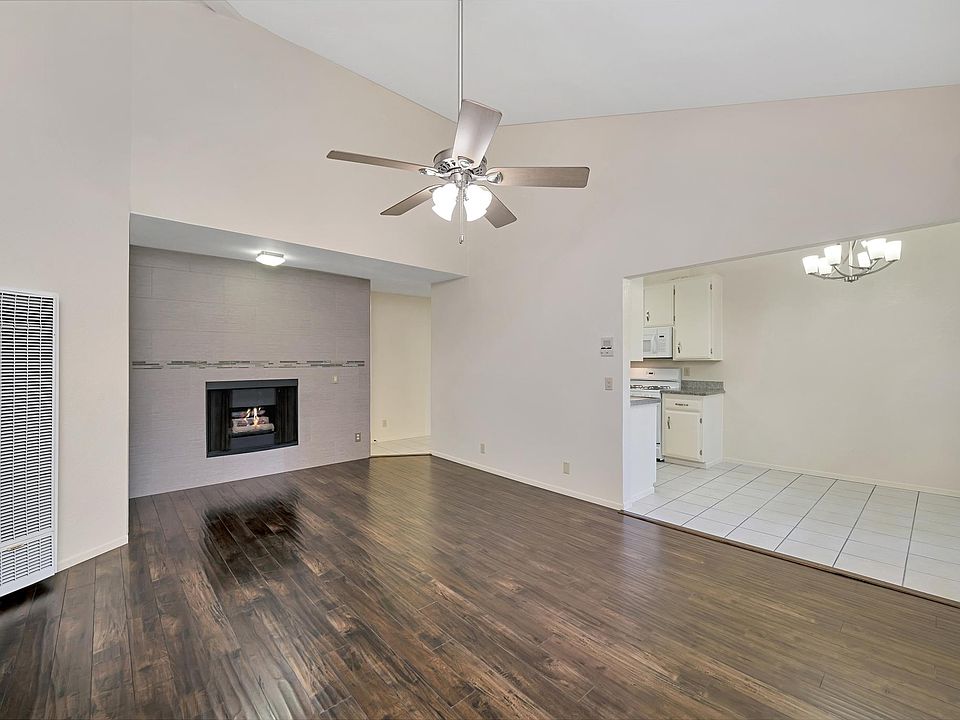 Living Room with Vaulted Ceilings, Fire Place, Heater, Air Conditioner and Ceiling Fan