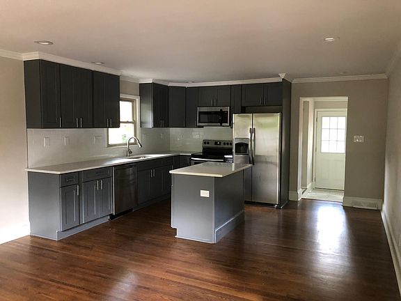 Renovated kitchen with room for two bar stools, dishwasher, disposal, microwave, electric range & oven and refrigerator and freezer with working ice maker.