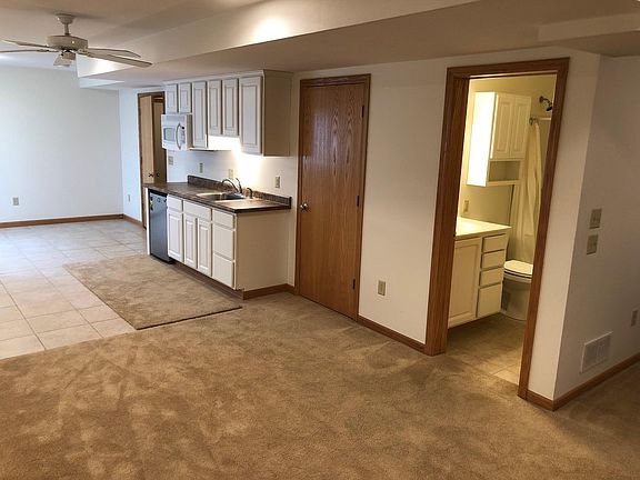View showing kitchenette, bath, storage closet between kitchenette and bath. Far door is entry door.