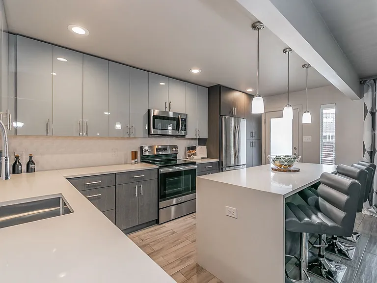 Cook in style with stainless appliances, sleek cabinetry, and quartz counters.