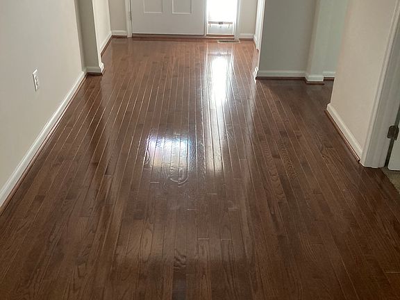 Front door entrance and entrance including hardwood floors.