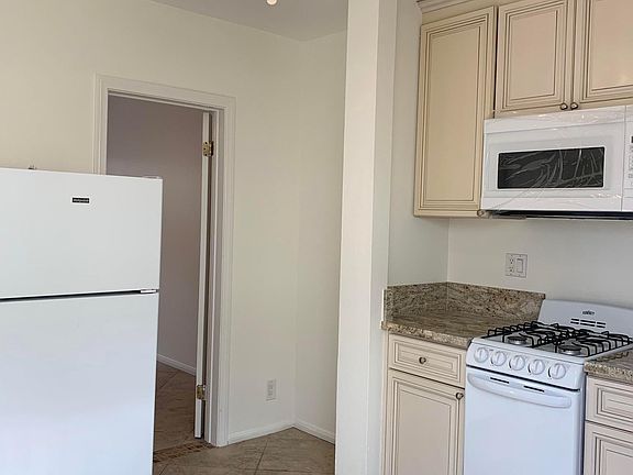 Kitchen view and door leading to bedroom.