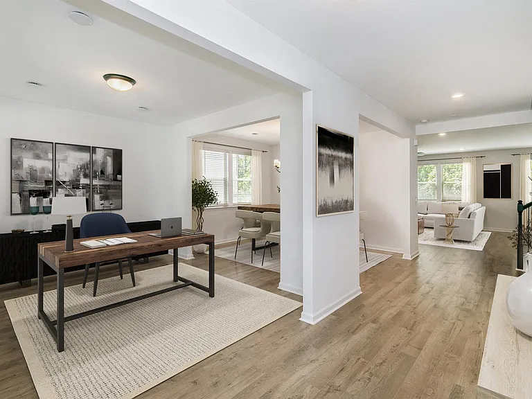 Home office off the entryway, flowing seamlessly into the living room.