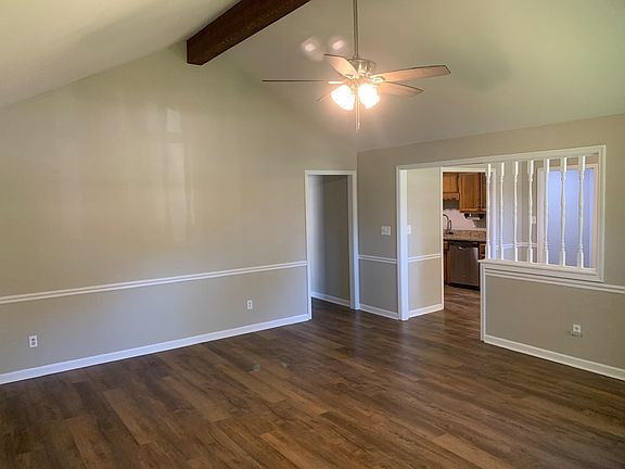 Living Room with vaulted ceiling looking into dining room and kitchen