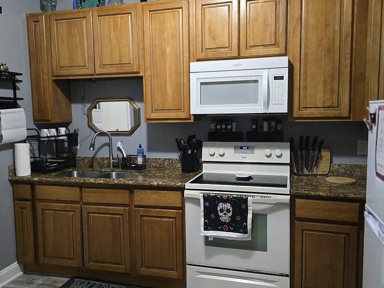 Fully stocked kitchen with utensils, pots, pans, toaster, keurig coffee, and dishes