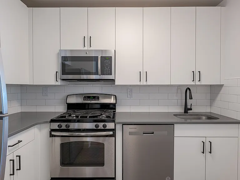 Sleek stainless steel appliances and modern cabinetry