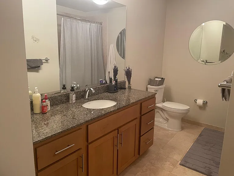 Bathroom with shower/tub and room for a hamper near the washer/dryer