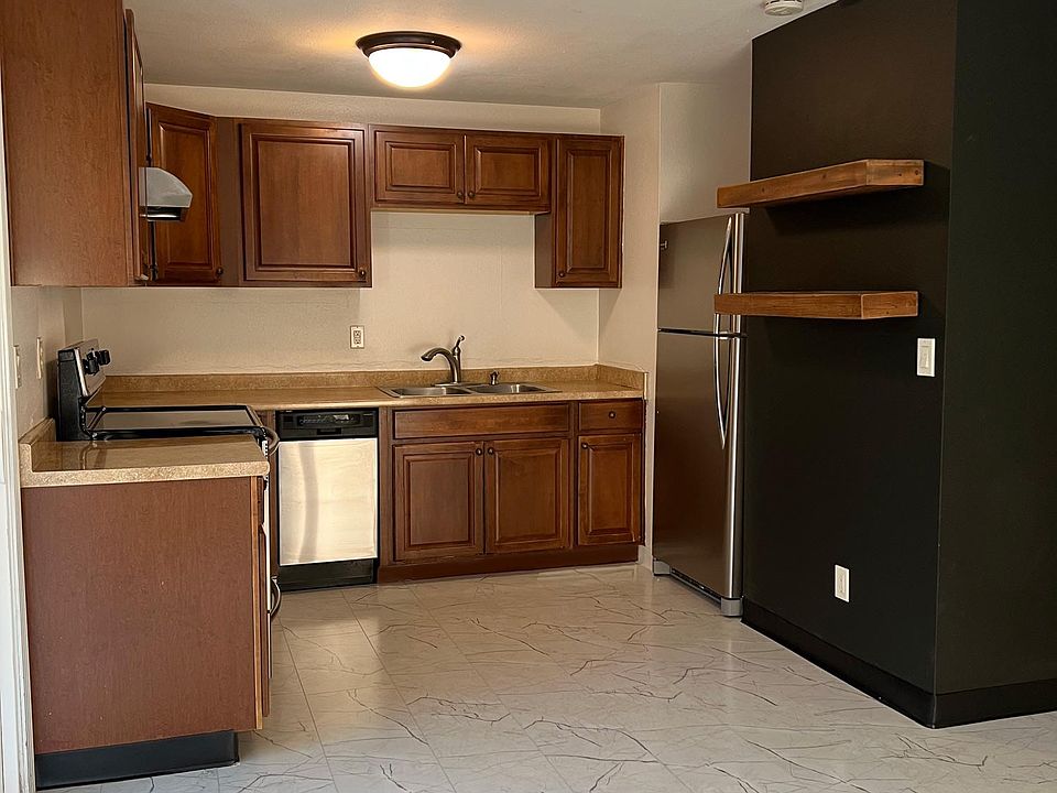 Open kitchen with updated appliances and dishwasher.
